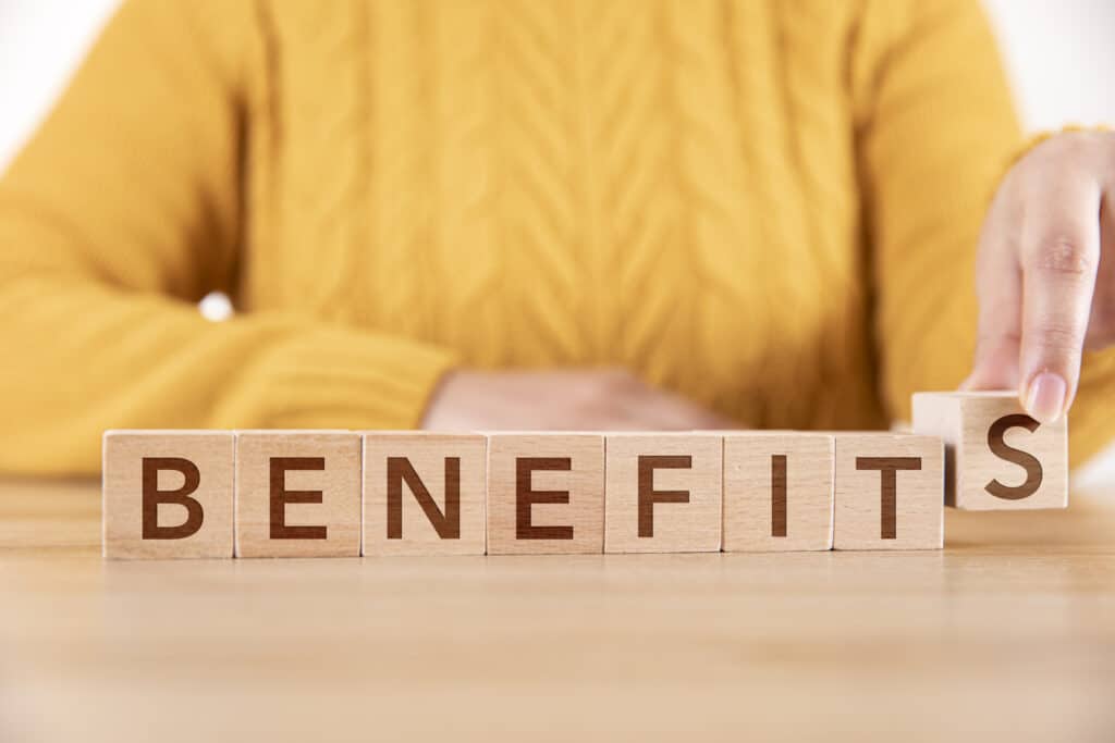Woman Arranging Wooden Cubes and Writing Benefits