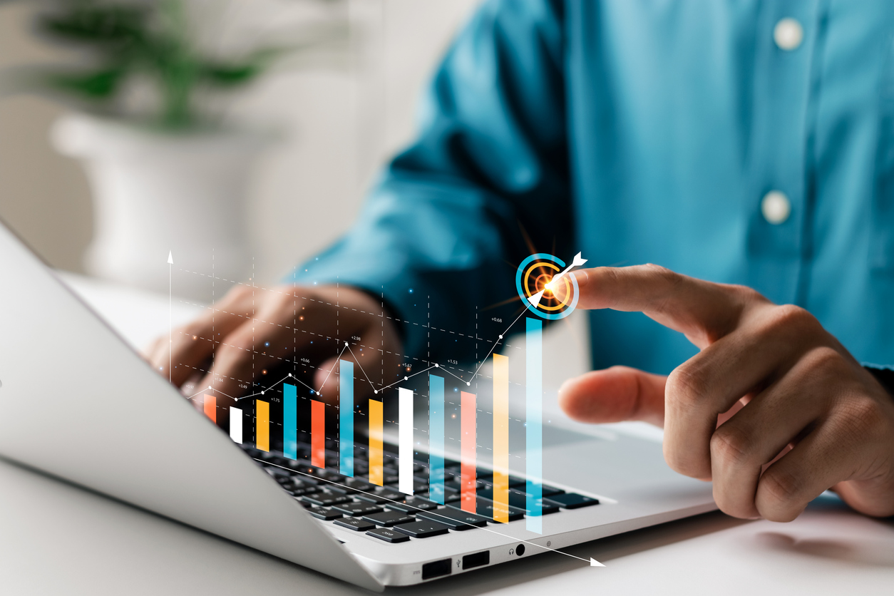 Businessman analyzing company's financial balance sheet working with digital augmented reality graphics. Businessman calculates financial data for long term investment.